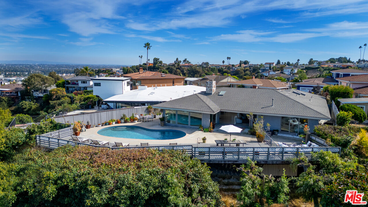 a view of a house with sitting area and a swimming pool