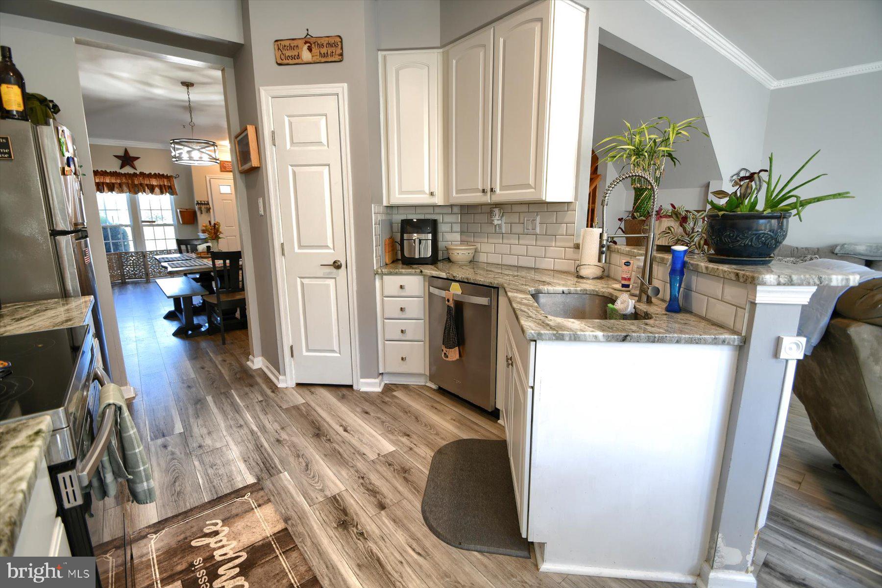 a kitchen with a refrigerator and a stove