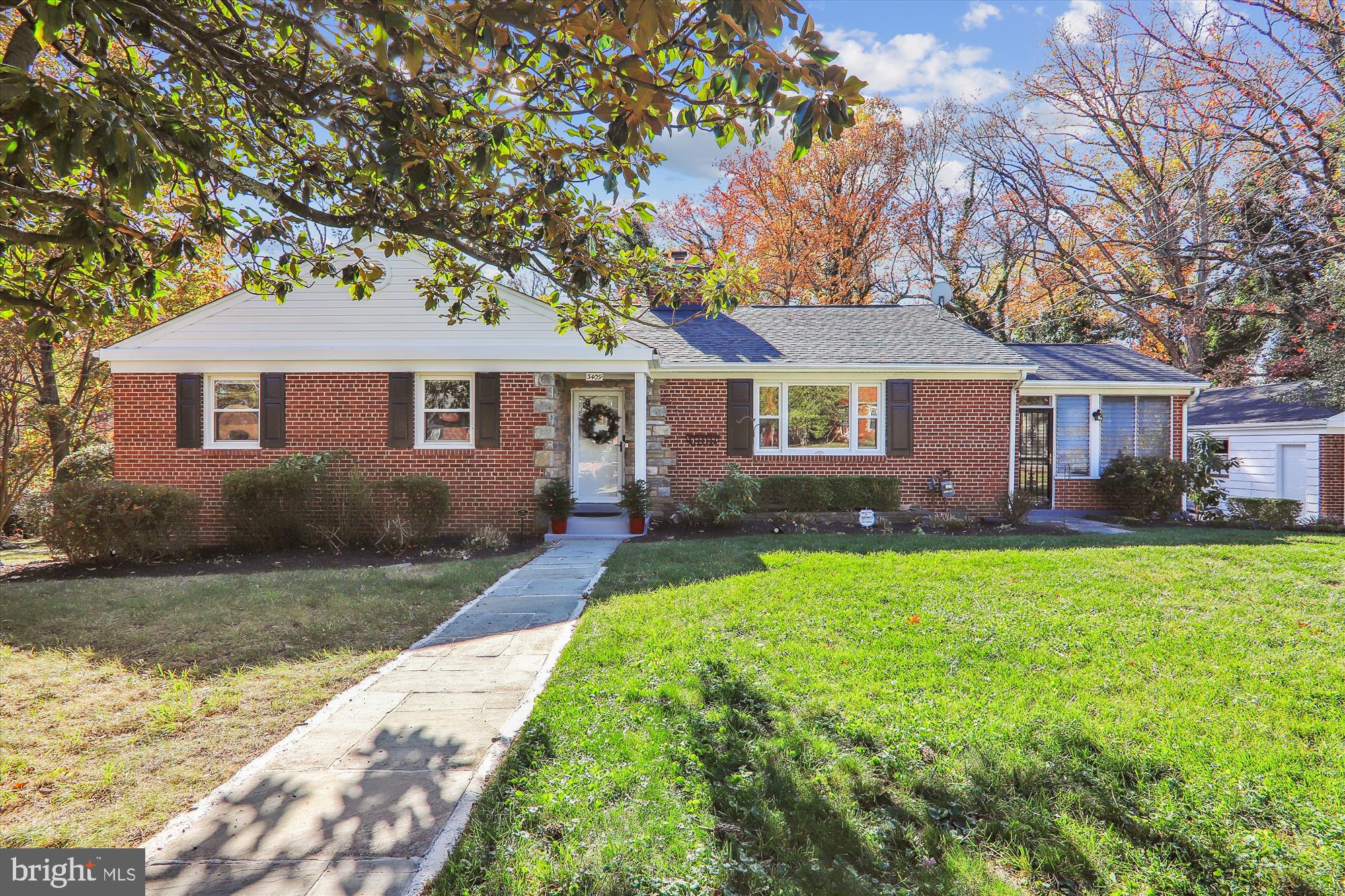 a front view of a house with yard porch and green space