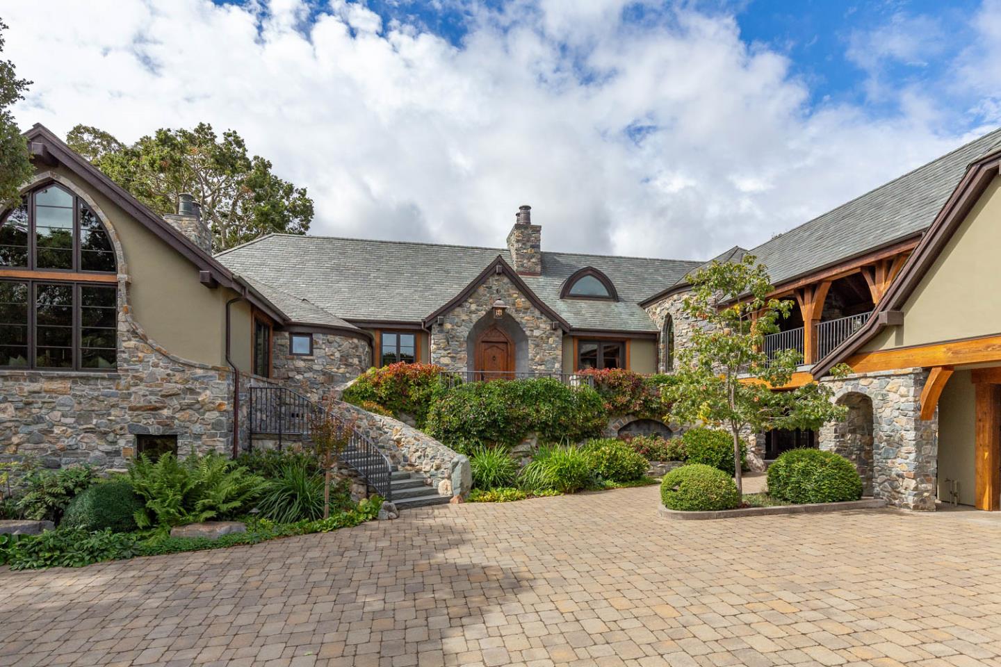 a front view of a house with a garden