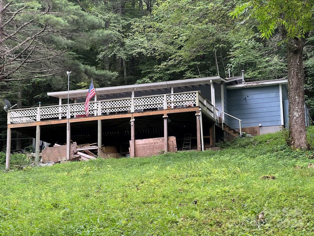 a view of a house with a yard and sitting area