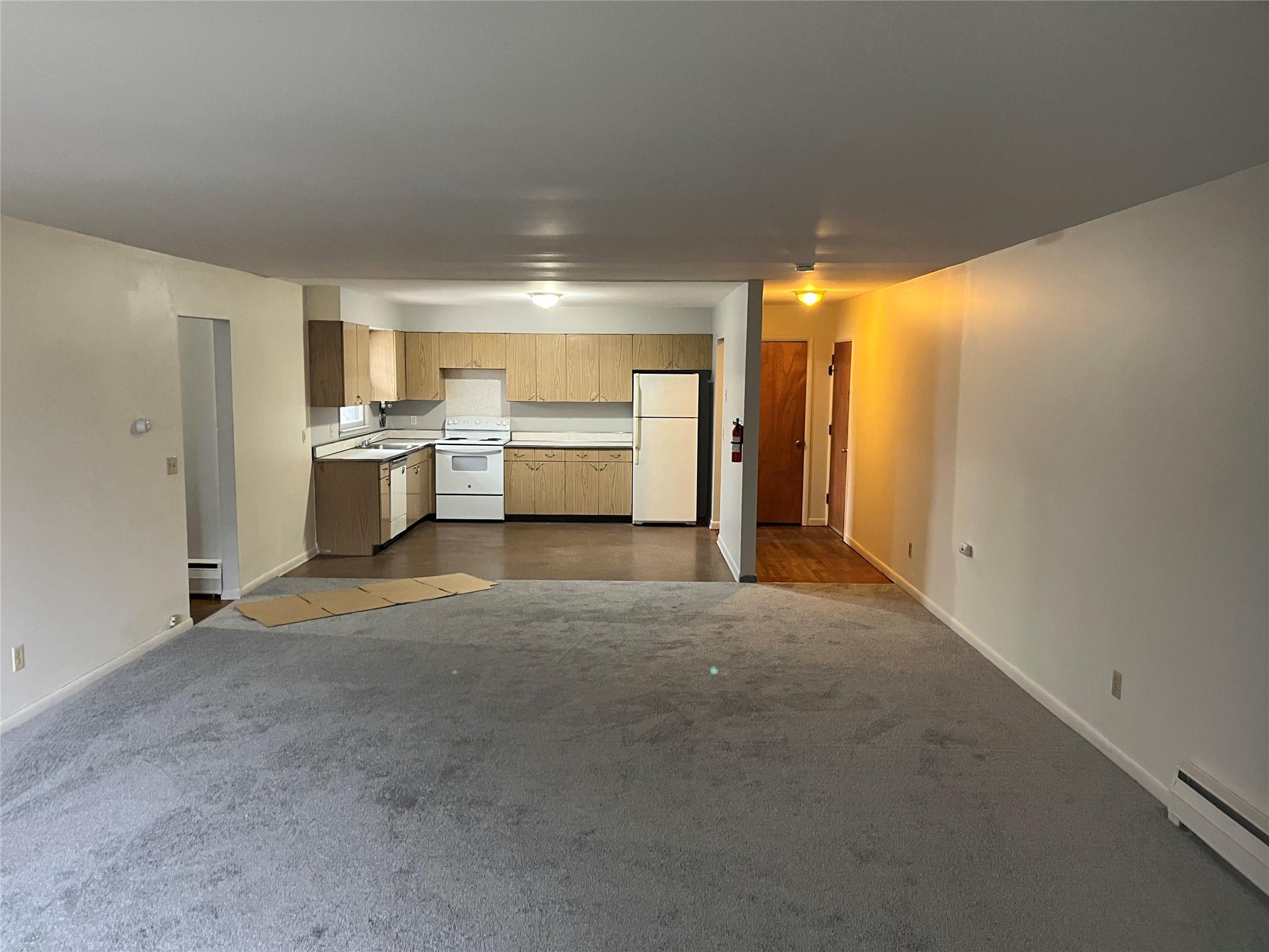 Living Room featuring baseboard heating, new carpet