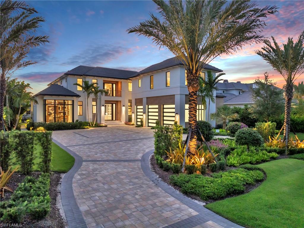 a front view of a house with a yard and outdoor seating