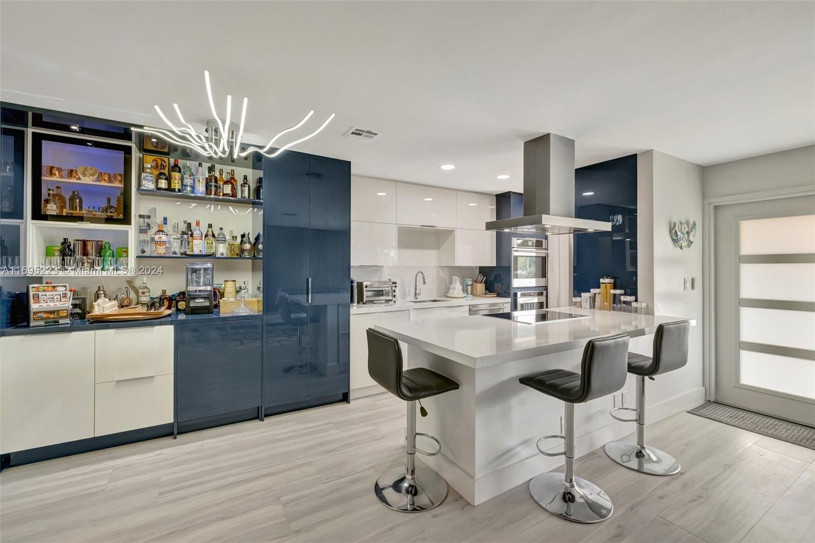 a kitchen with stainless steel appliances kitchen island granite countertop a table and chairs in it