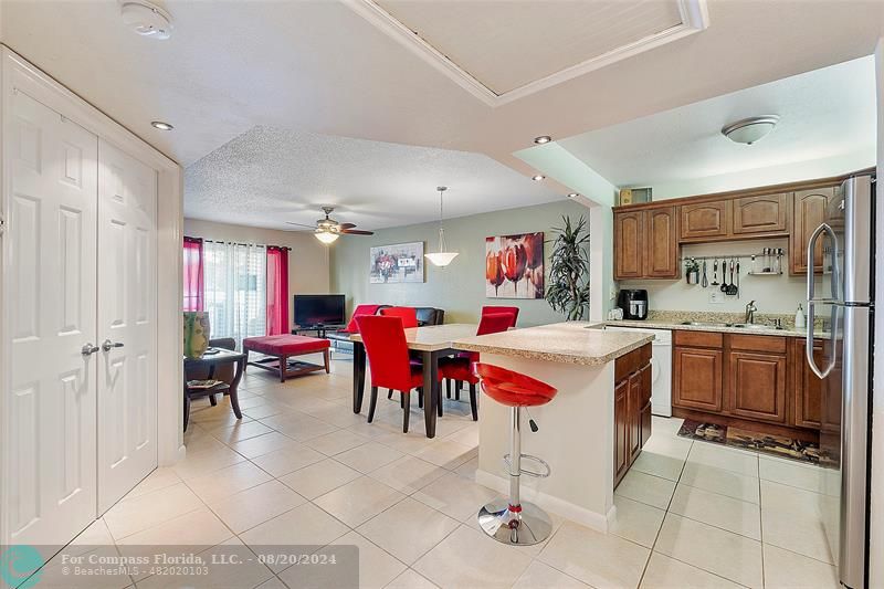 a large white kitchen with cabinets and stainless steel appliances