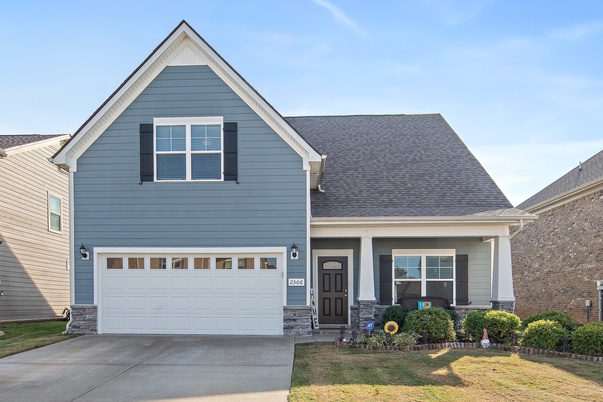 a front view of a house with garden