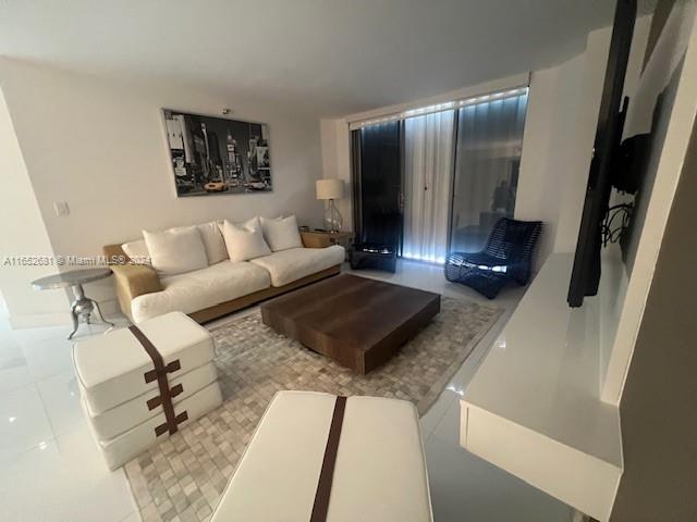 a living room with furniture rug and a table