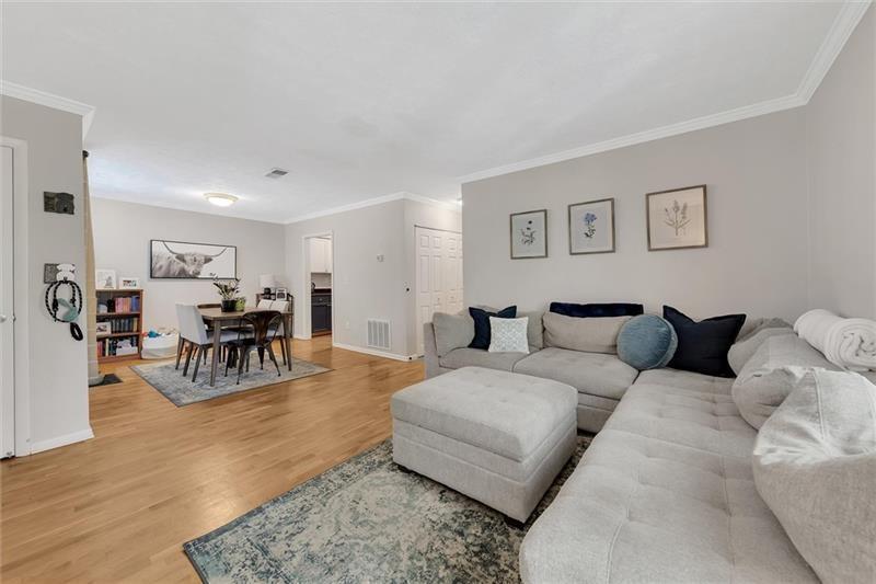 a living room with furniture and wooden floor