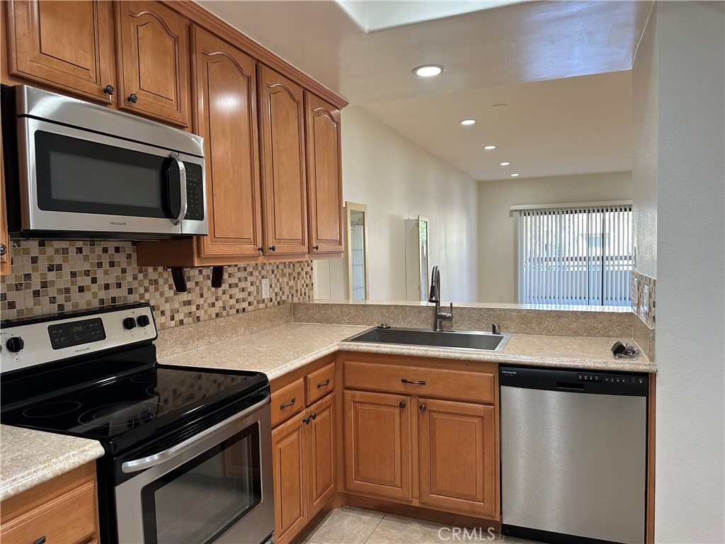 a kitchen with a sink stove and microwave