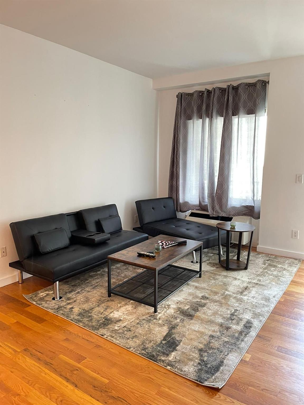 a living room with a couch and window