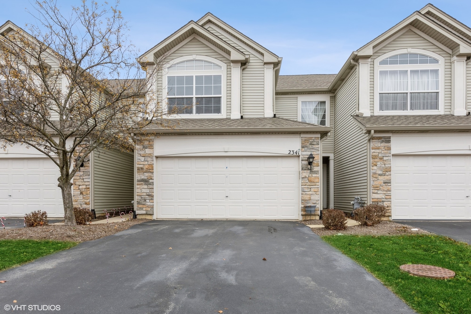 a front view of a house with a yard and garage