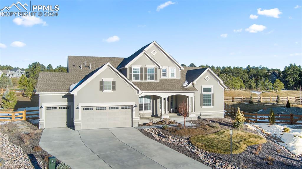 View of front of house with a porch and a garage