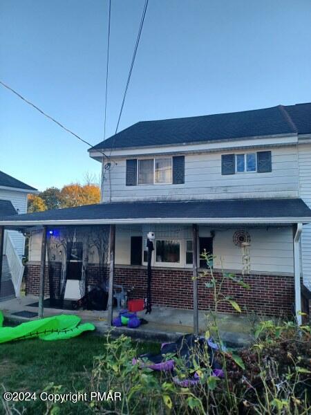 a view of a house with a porch and furniture