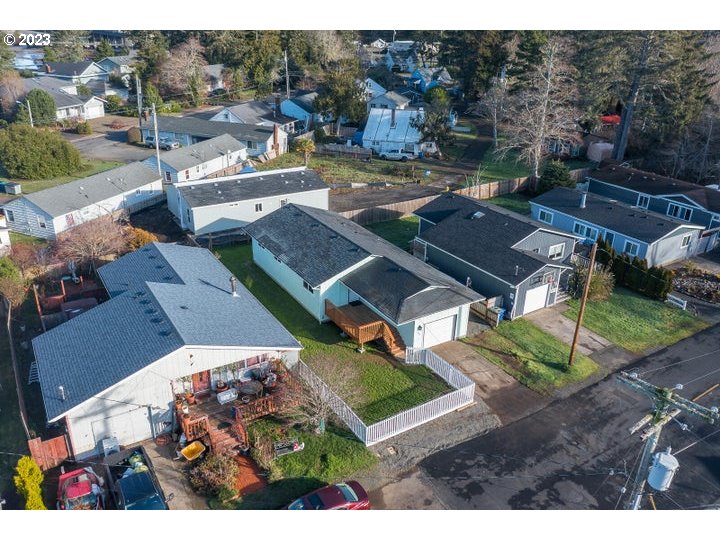 an aerial view of a house with garden space and street view