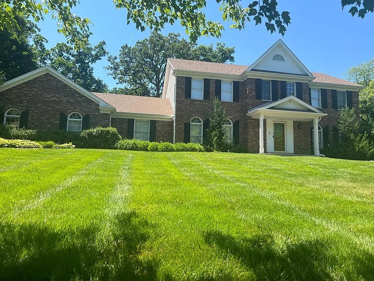 a front view of a house with a yard