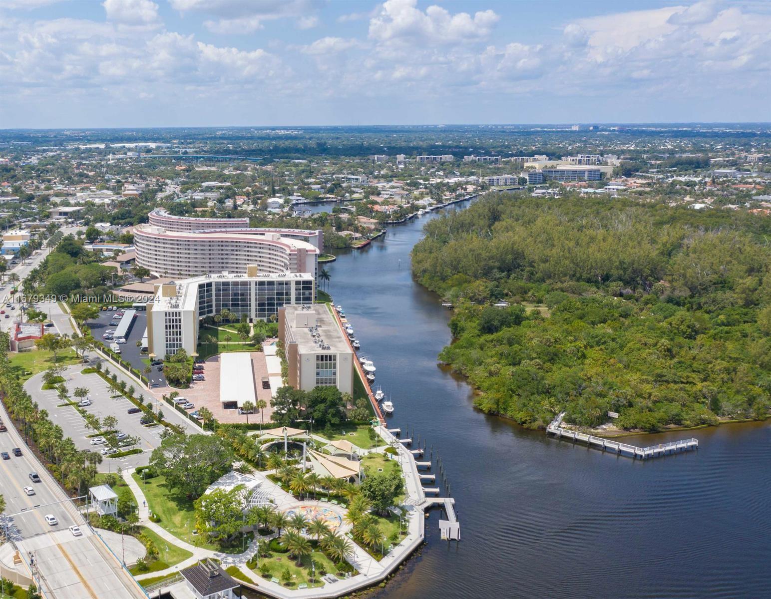 an aerial view of a house with a yard and lake view in back