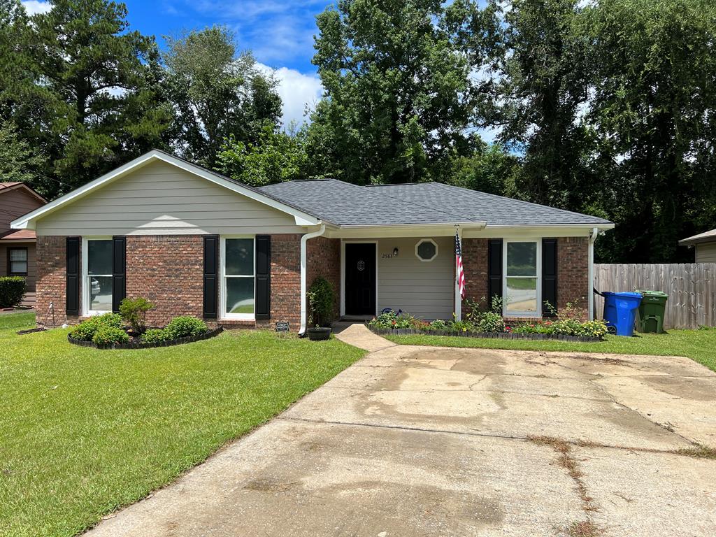 a front view of a house with a yard and porch