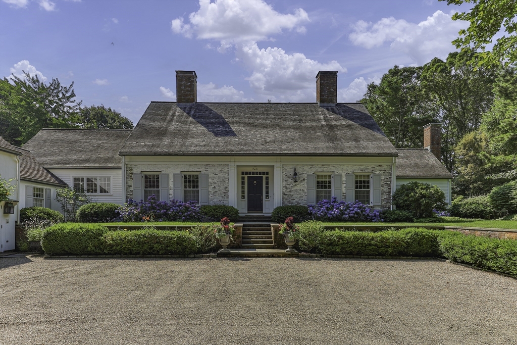 a front view of a house with a garden