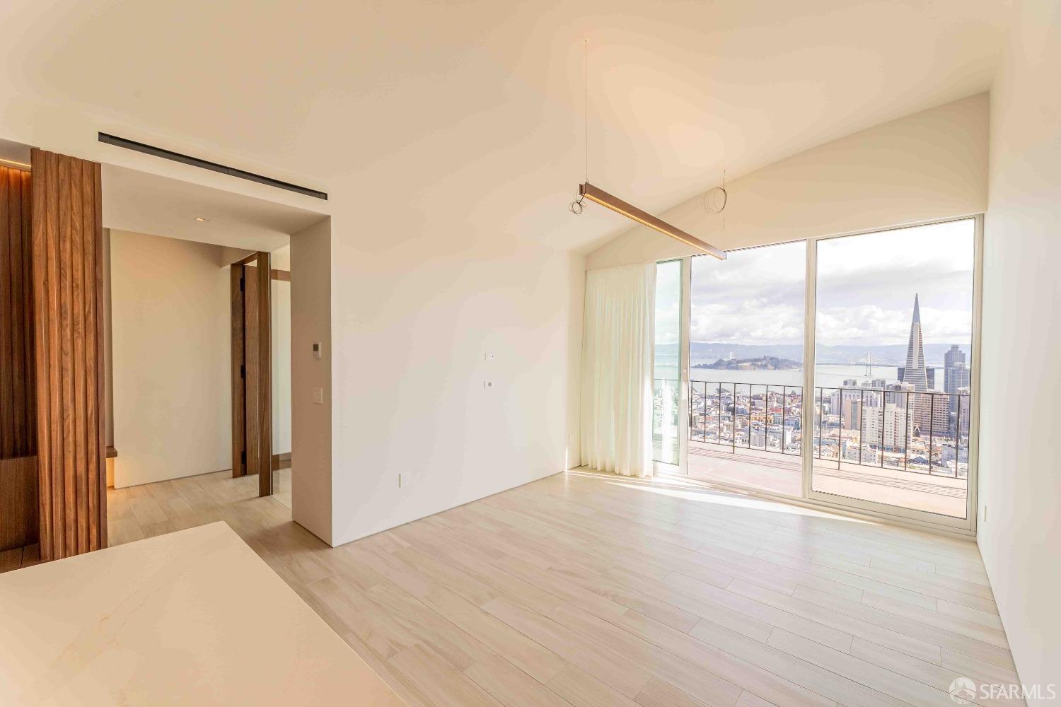 a view of a room with wooden floor and a window