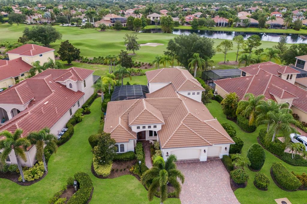 an aerial view of a house with garden space and lake view