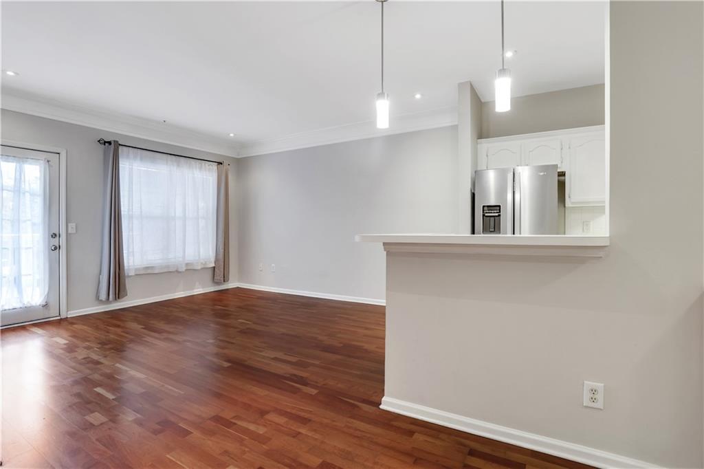 a view of a kitchen with a dishwasher and wooden floor