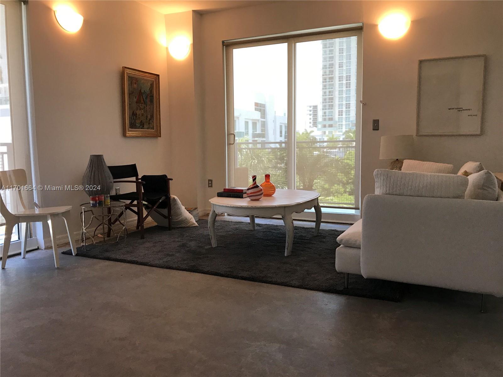 a living room with furniture and a window