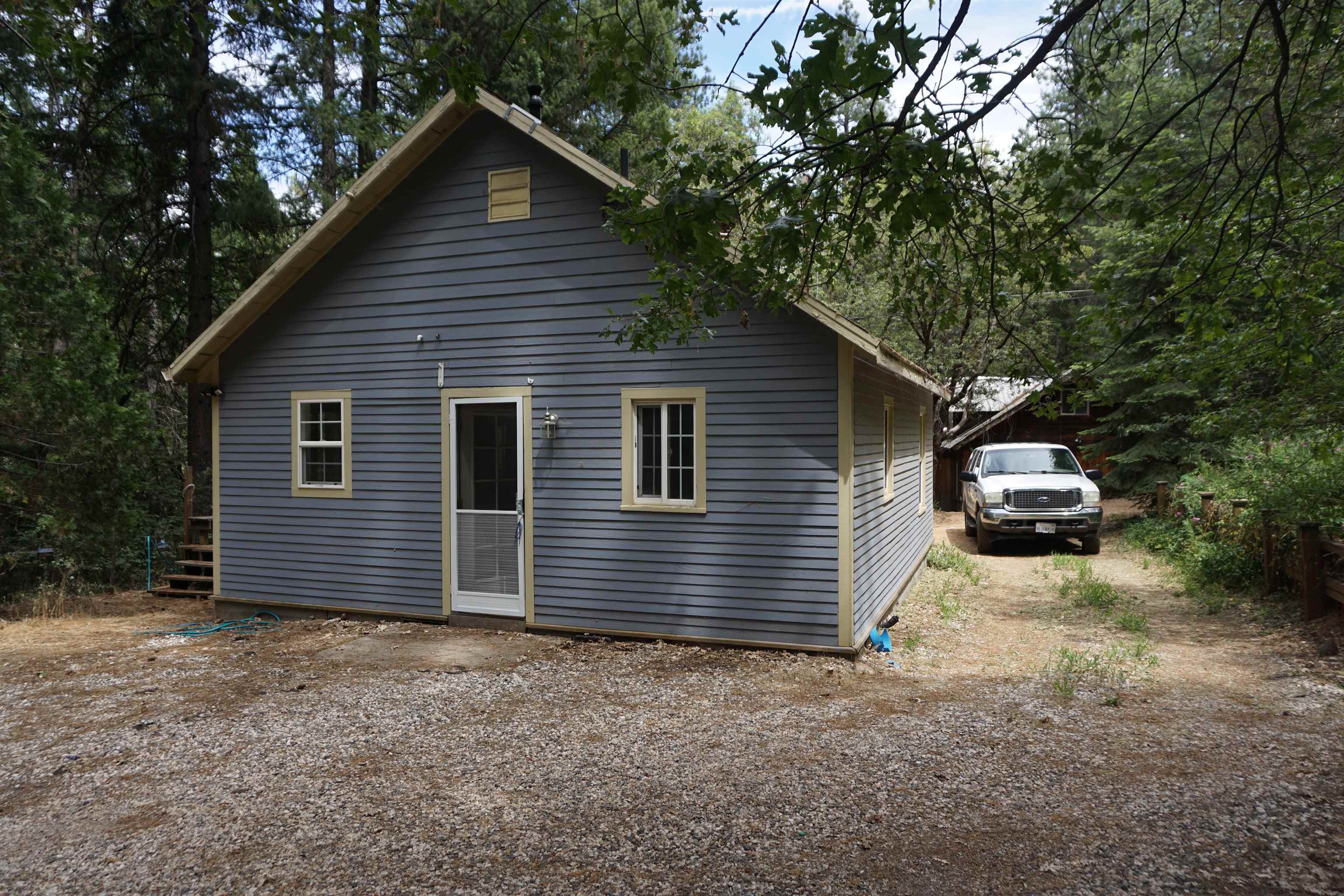 a view of a house with a yard and garage