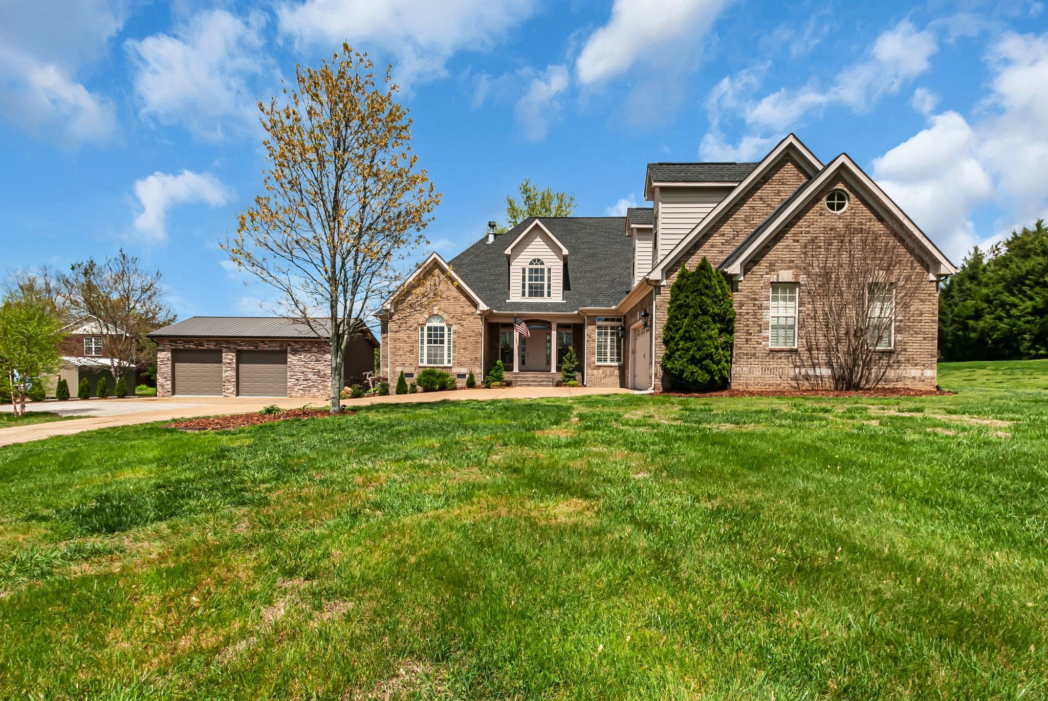 a front view of a house with a garden