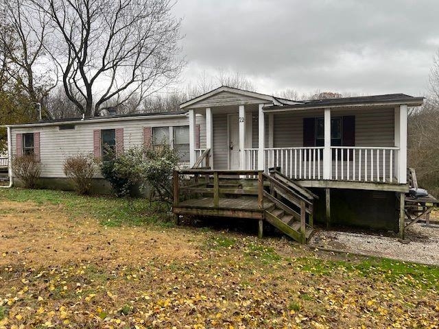 Rear view of property with a porch and a yard