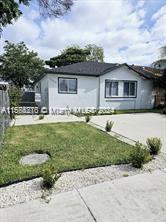 a front view of a house with a garden and yard