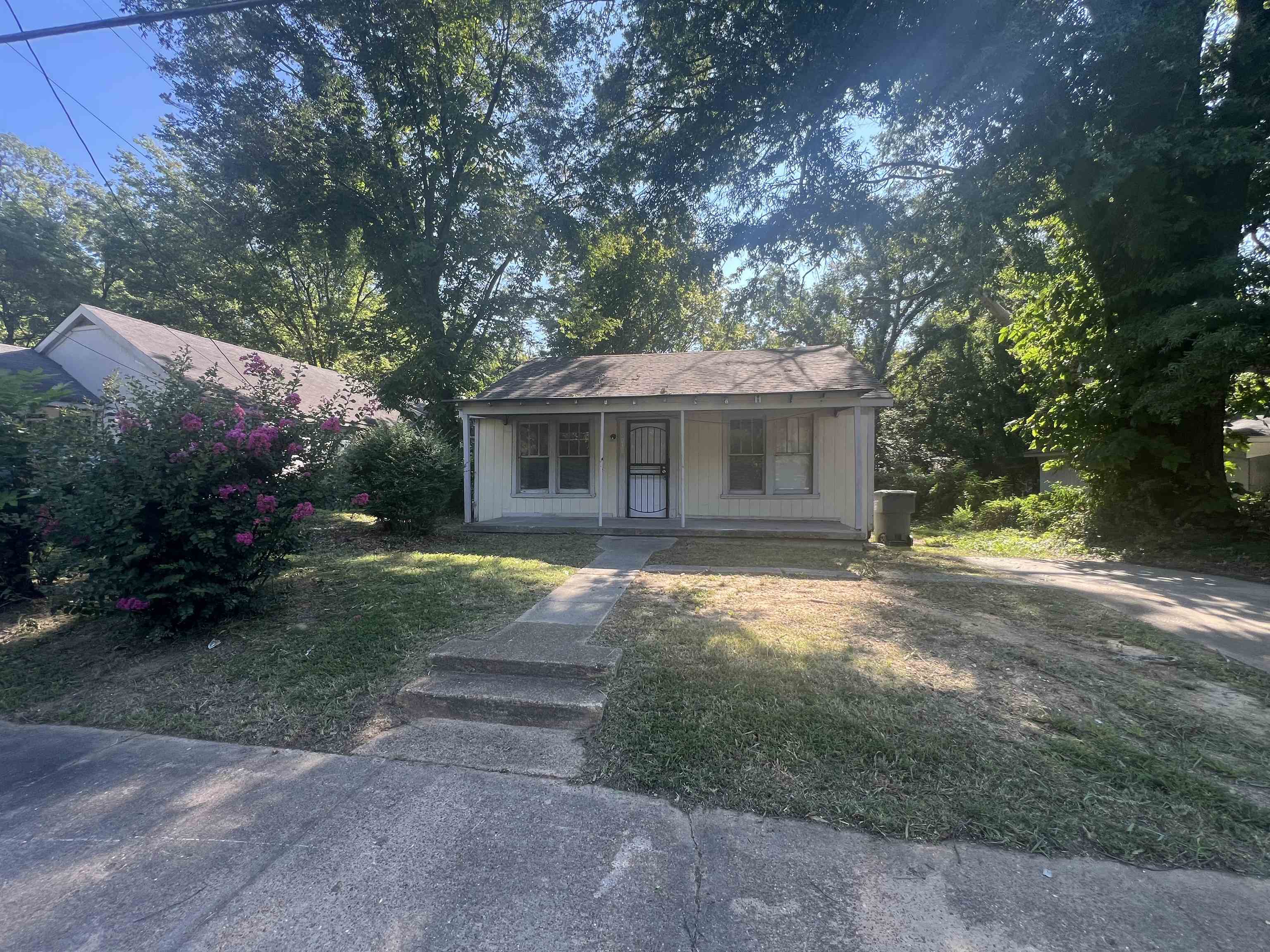 Bungalow with a front yard and a porch