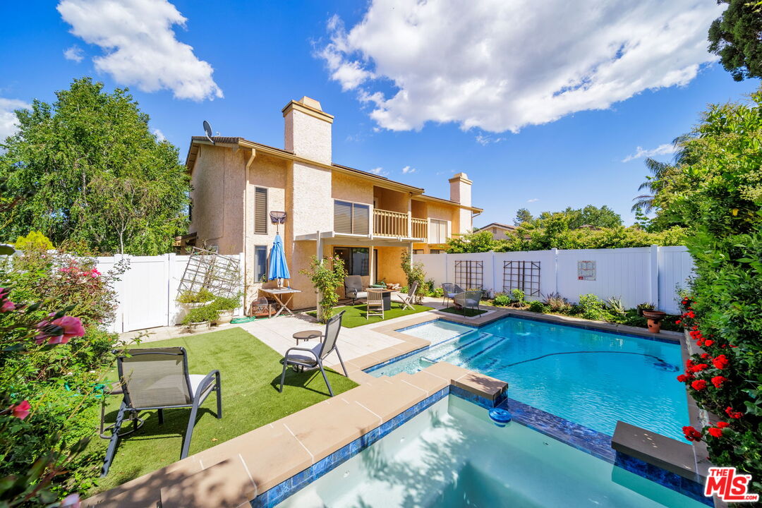 a view of swimming pool with outdoor seating and plants