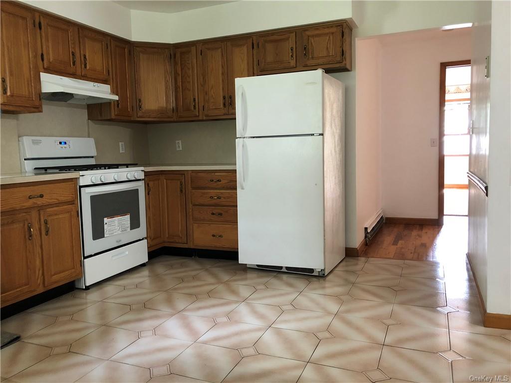 a kitchen with a refrigerator sink stove and cabinets