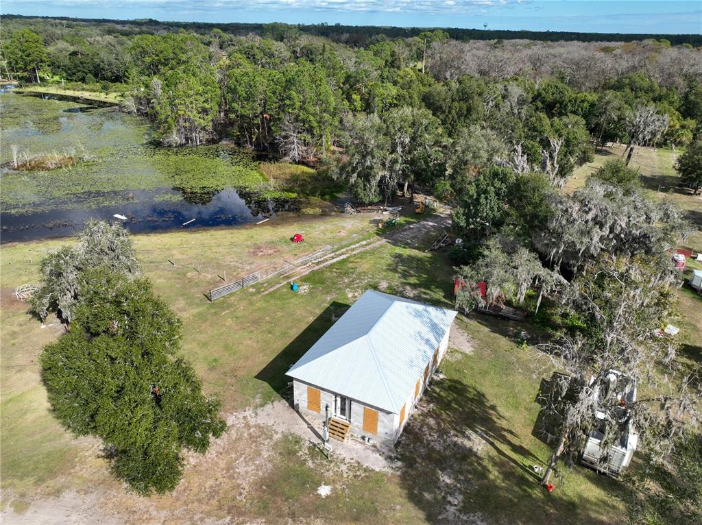 an aerial view of a house with a yard