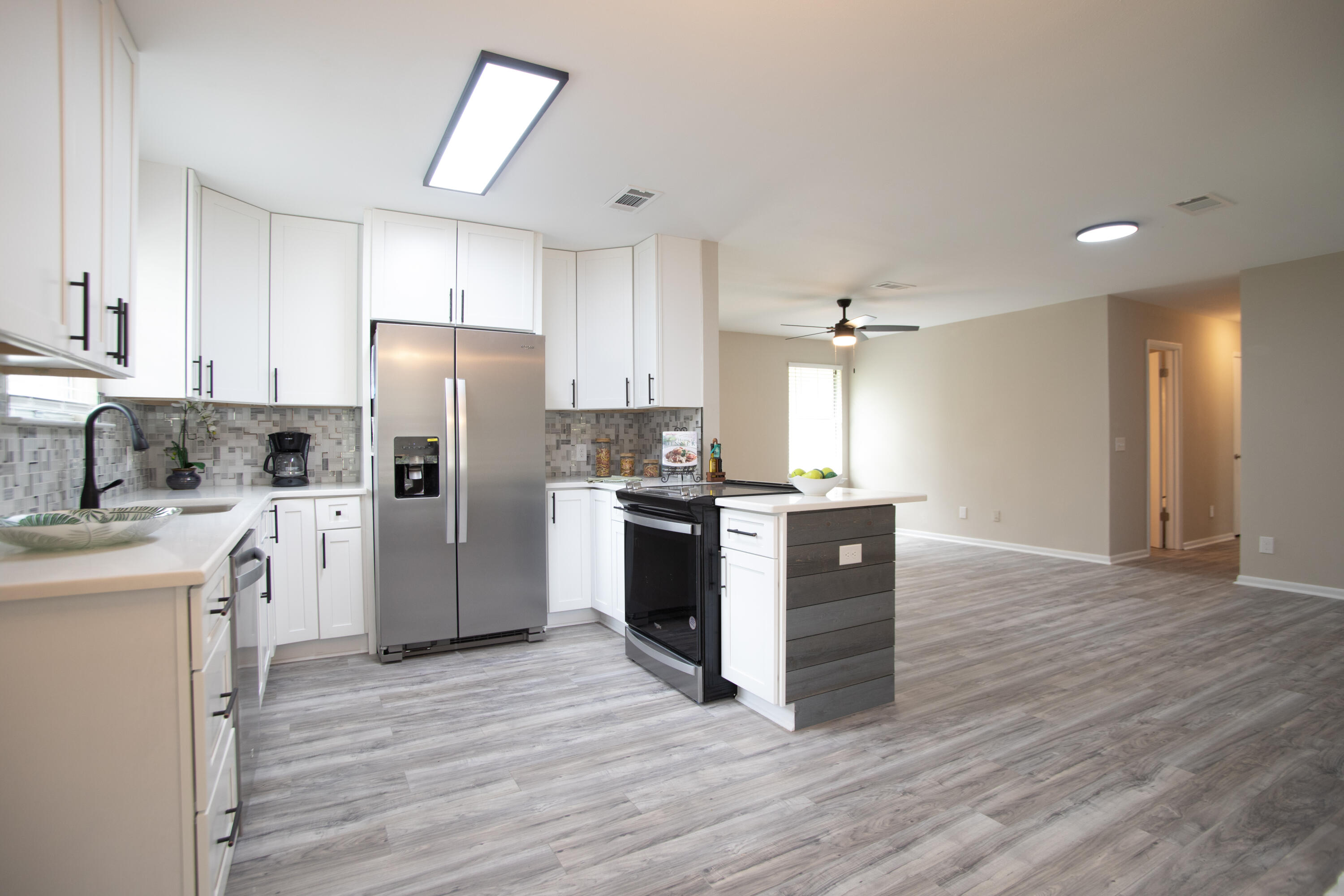 a kitchen with a refrigerator and a stove top oven