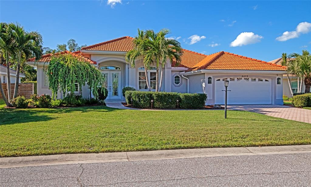 a front view of a house with a garden