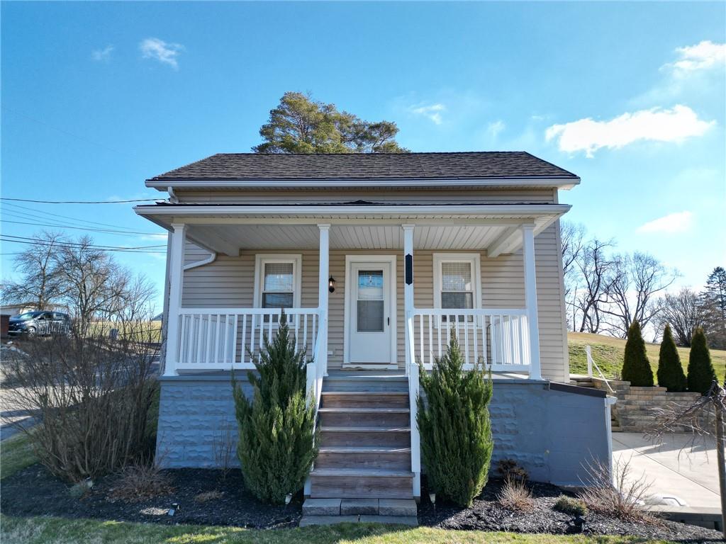 a view of a house with a small yard and plants