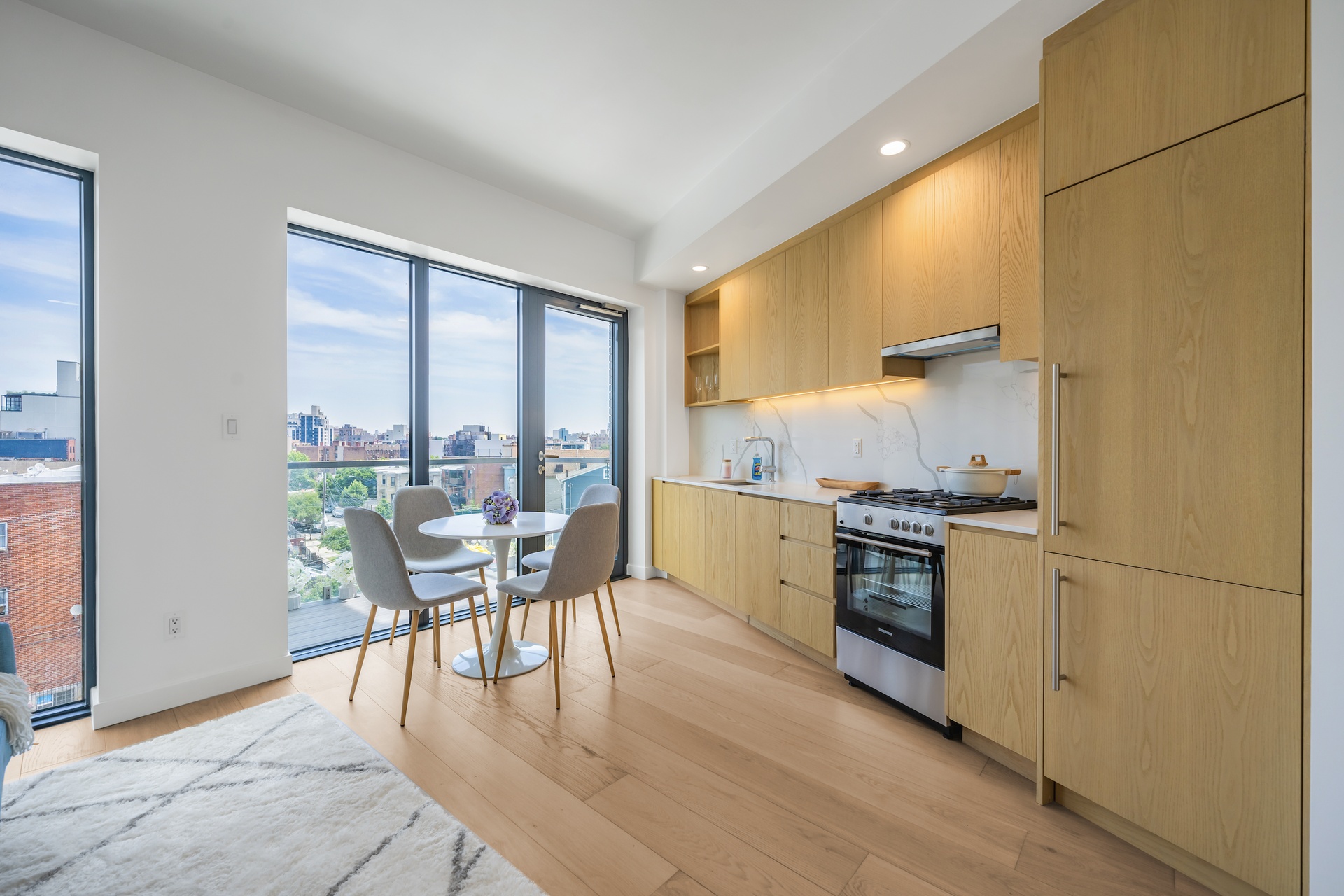 a kitchen with a table chairs and a wooden floor