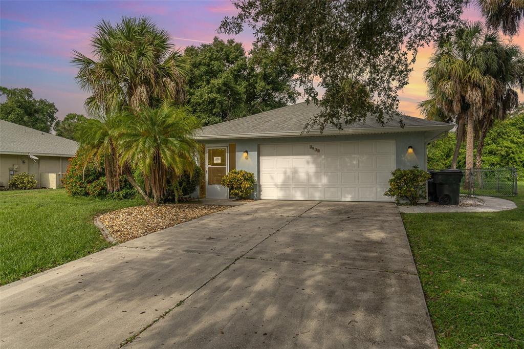 a front view of a house with a yard and a garage