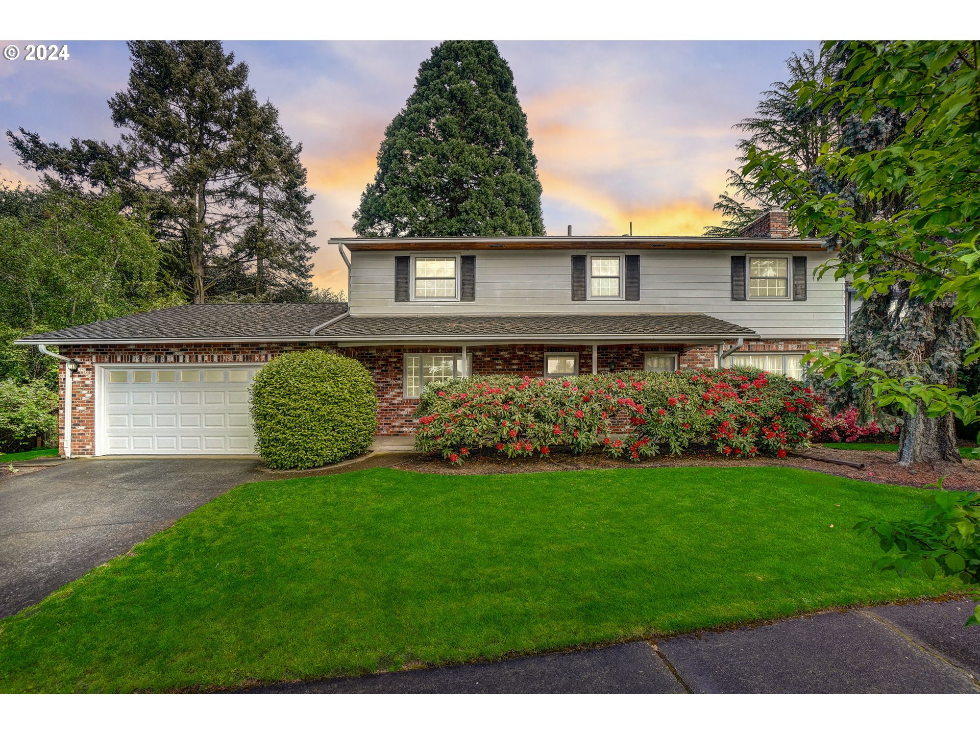 a front view of a house with a garden