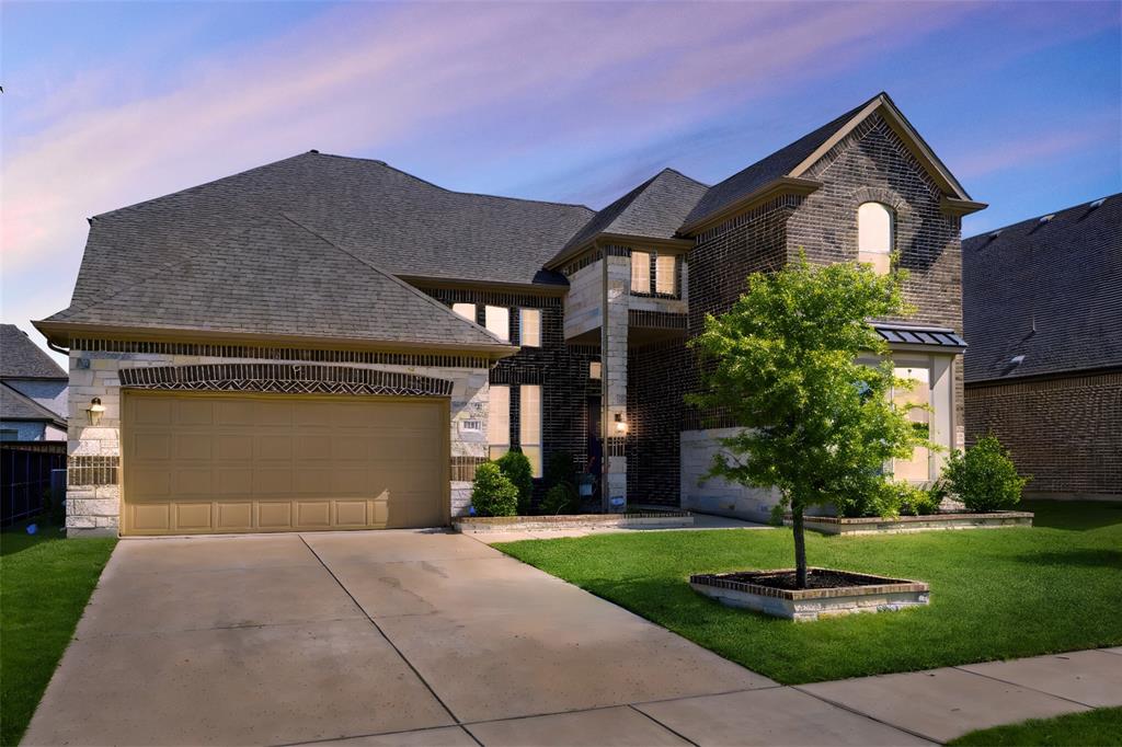 a front view of a house with a yard and a garage