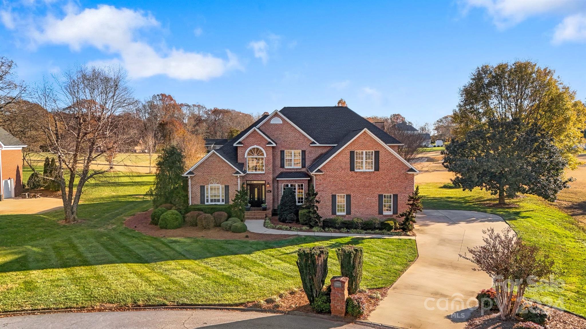 a front view of house with yard and green space