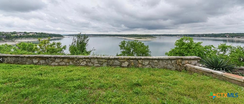 a view of lake with a big yard