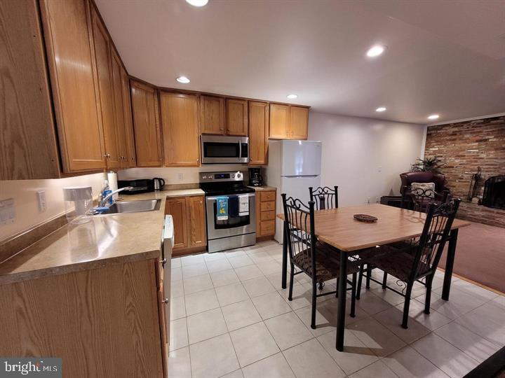 a kitchen with kitchen island granite countertop a sink a counter top space and appliances