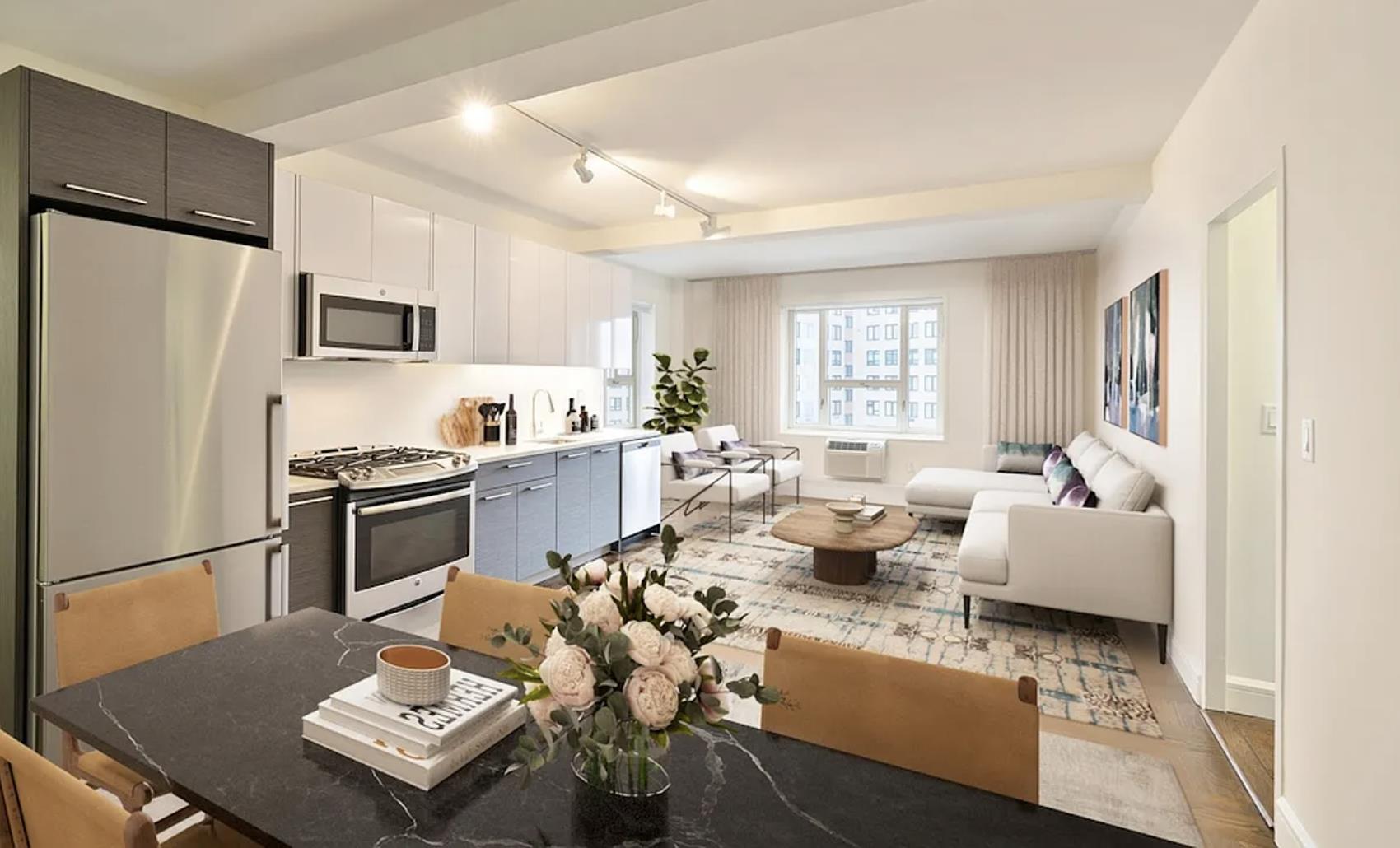 a living room with stainless steel appliances furniture a rug and a window