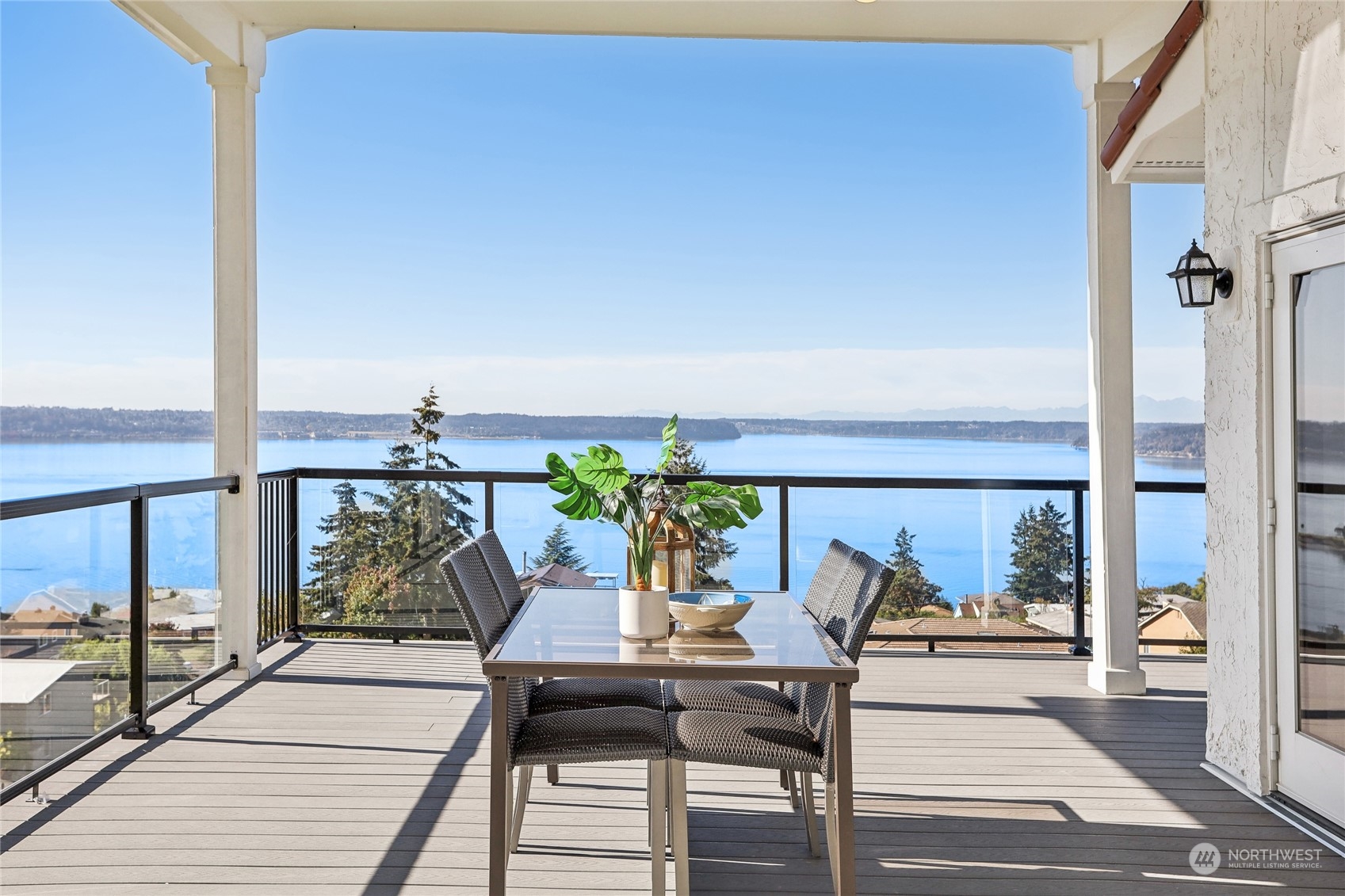 a view of a balcony with chairs and wooden floor