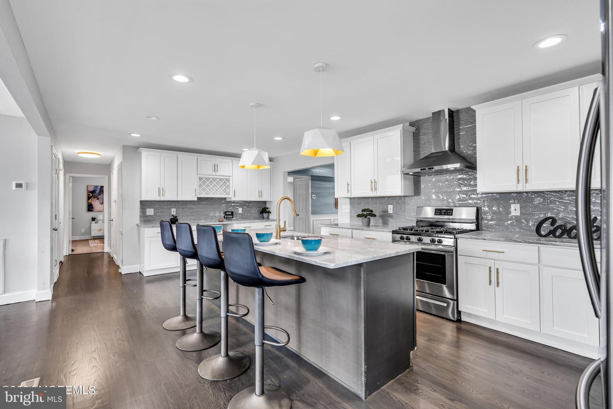 a kitchen with stainless steel appliances kitchen island granite countertop a sink and cabinets