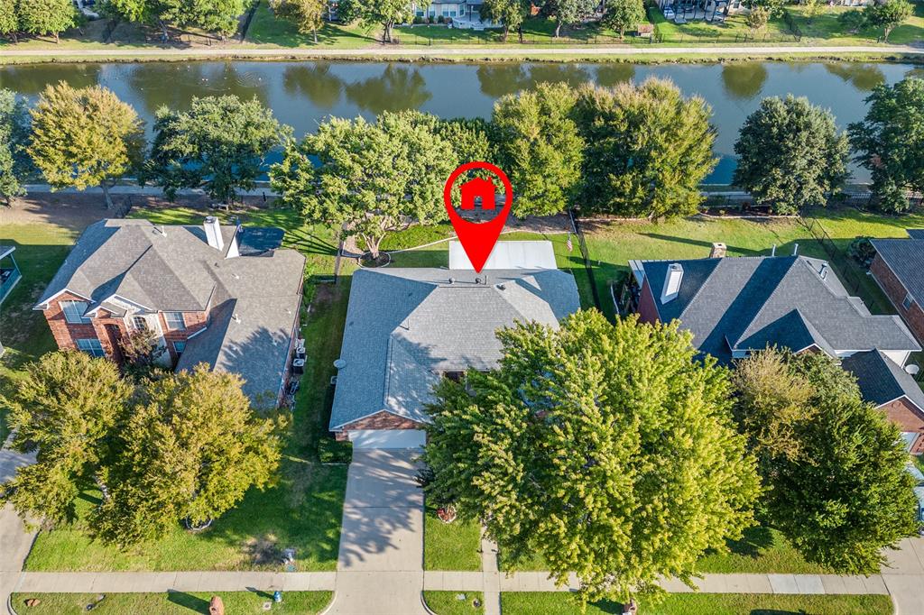 an aerial view of a house with a lake swimming pool and outdoor seating