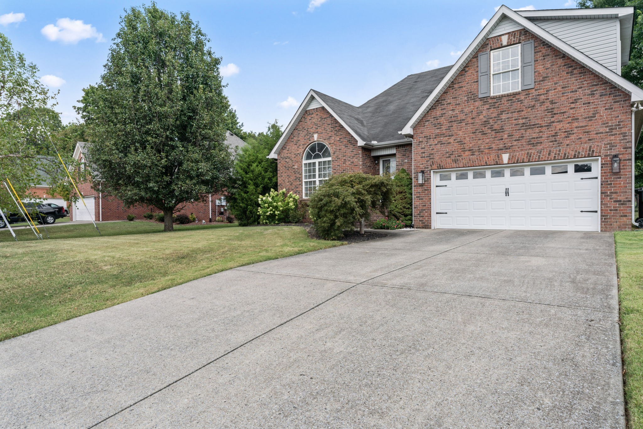 Charming all brick home with nicely landscaped front entrance path to front patio. Driveway offers space for extra parking. Spacious 2 car garage!