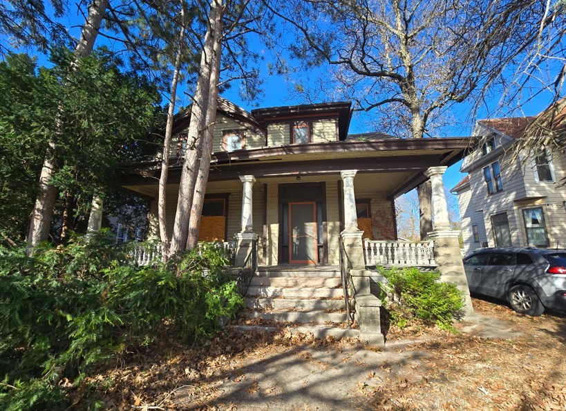 a front view of a house with a garden